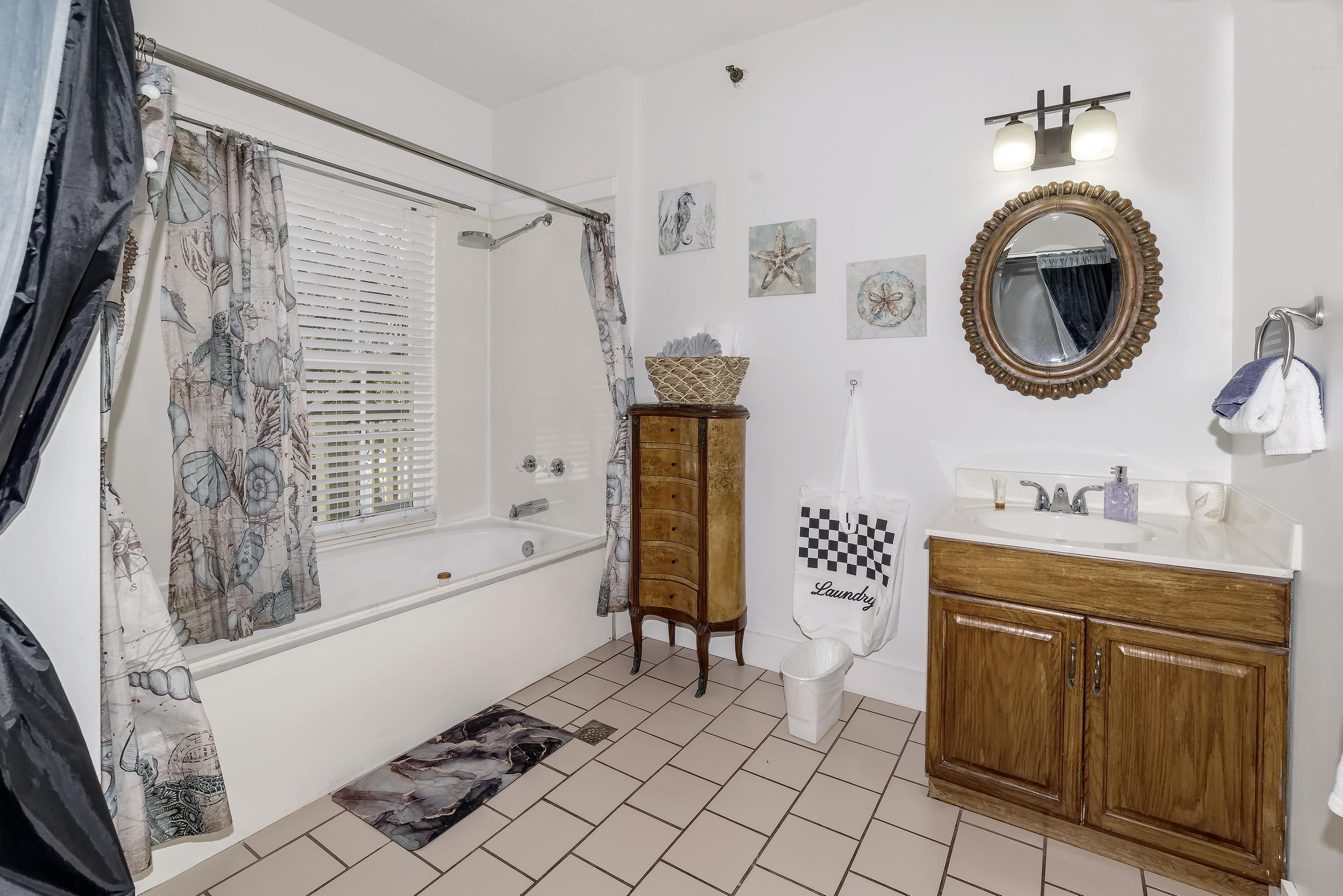 29 Cuna Street St. Augustine, FL 32084 - Photo 28 of 69 a bathroom with a bathtub sink mirror and a shower