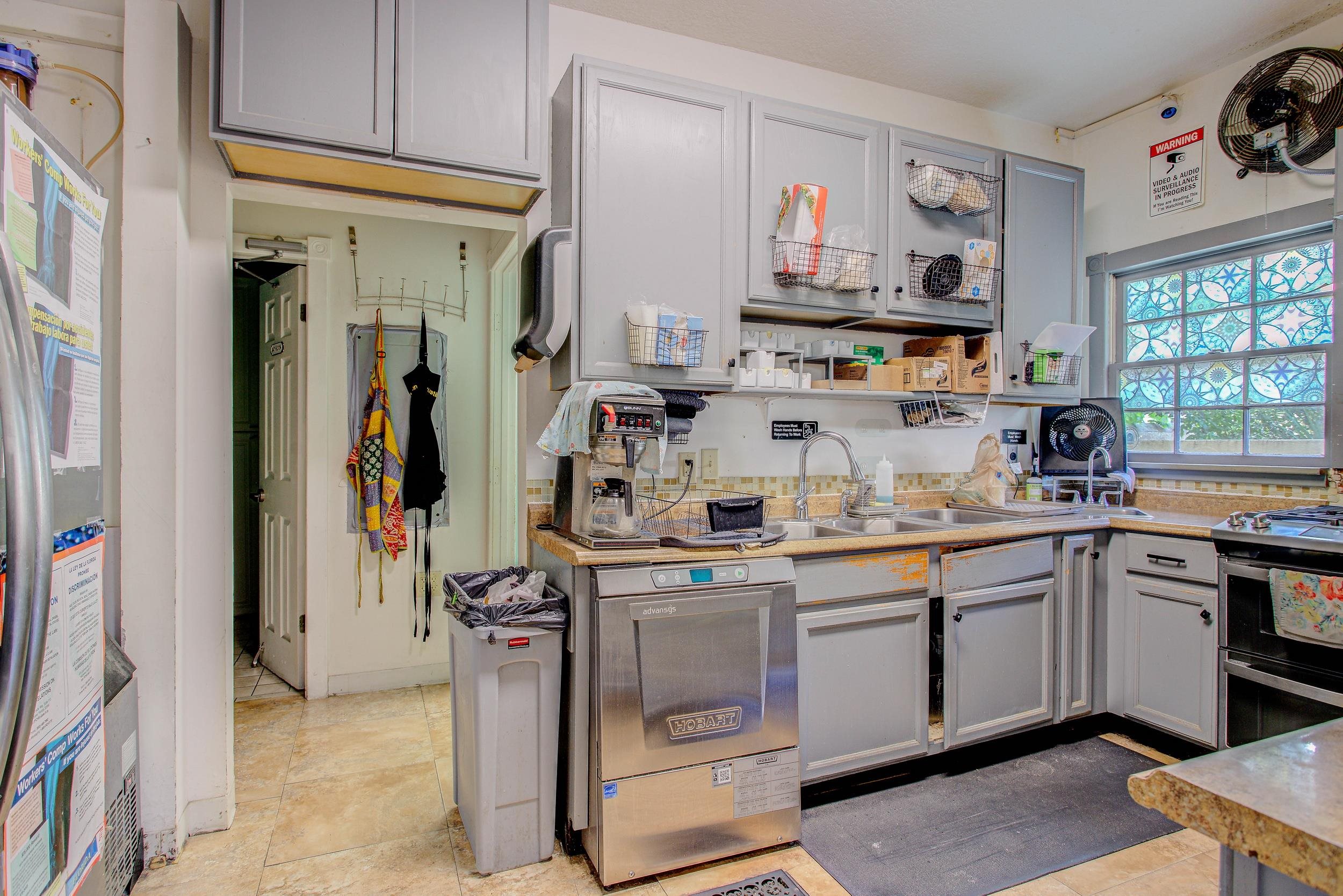 29 Cuna Street St. Augustine, FL 32084 - Photo 32 of 69 Kitchen with gray cabinetry, light countertops, light tile patterned flooring, refrigerator, and open shelves