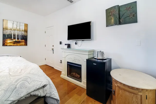 a bedroom with a bed and a flat screen tv