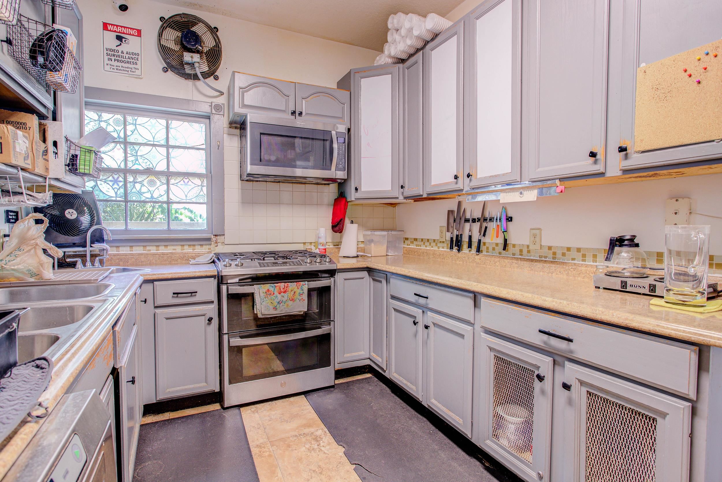 29 Cuna Street St. Augustine, FL 32084 - Photo 33 of 69 Kitchen with appliances with stainless steel finishes, decorative backsplash, and gray cabinetry