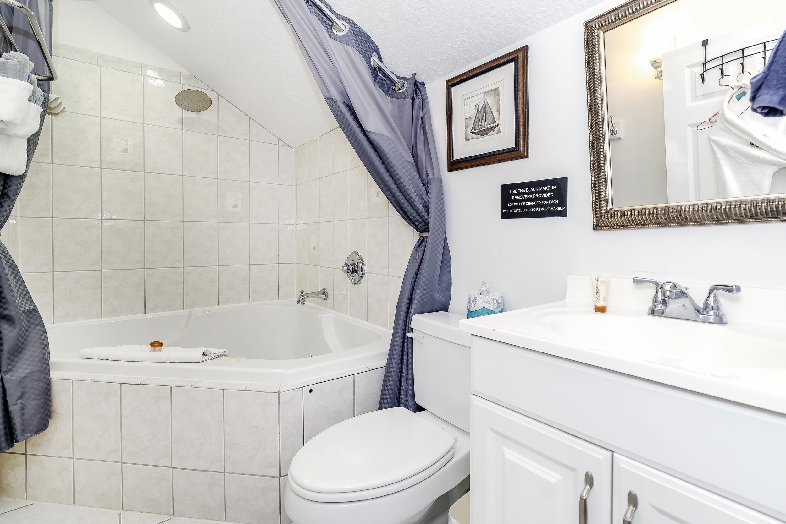 29 Cuna Street St. Augustine, FL 32084 - Photo 45 of 69 Bathroom with tiled shower / bath combo, lofted ceiling, and vanity
