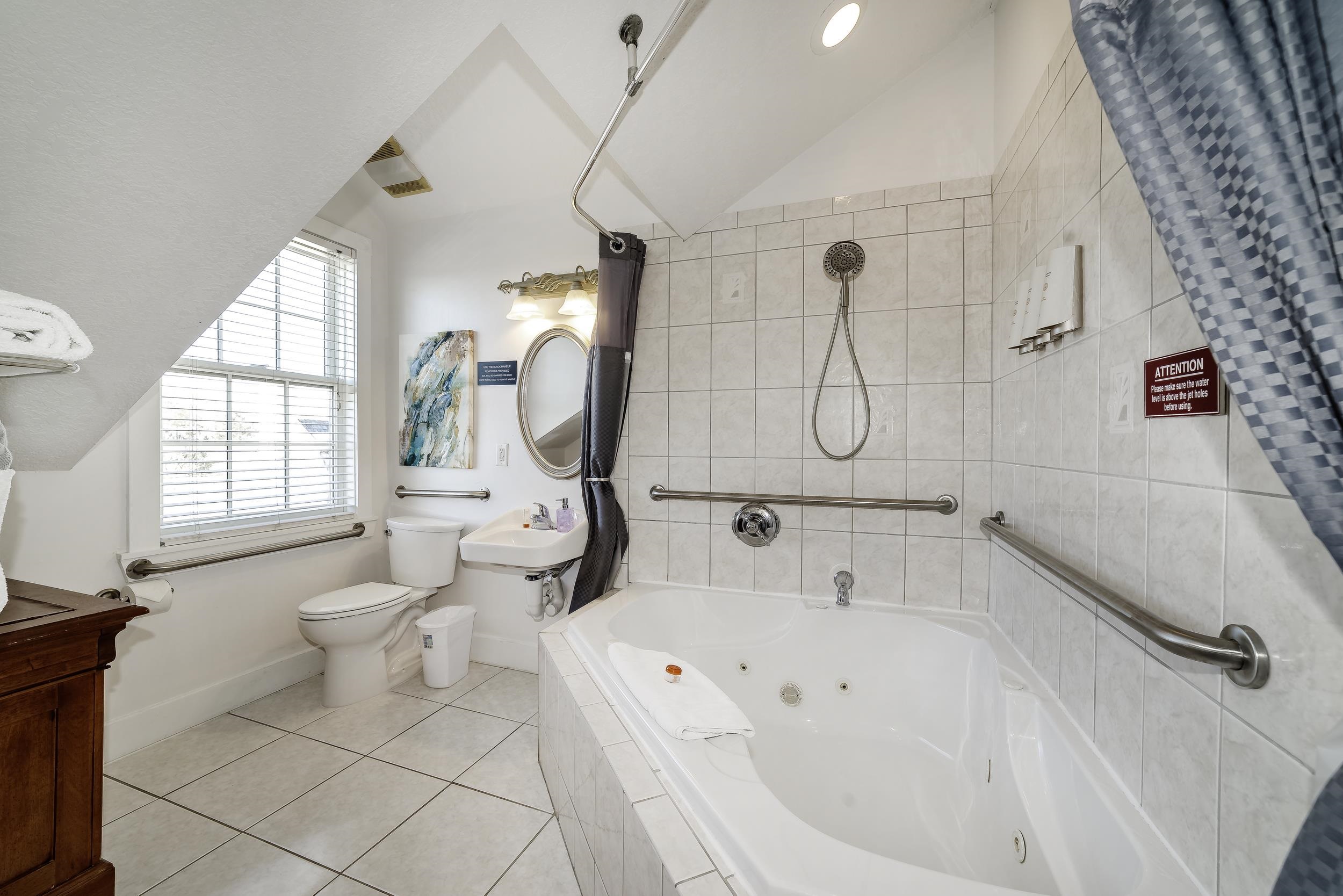 29 Cuna Street St. Augustine, FL 32084 - Photo 45 of 69 Bathroom with light tile patterned flooring, vaulted ceiling, a combined bath / shower with jetted tub, and vanity