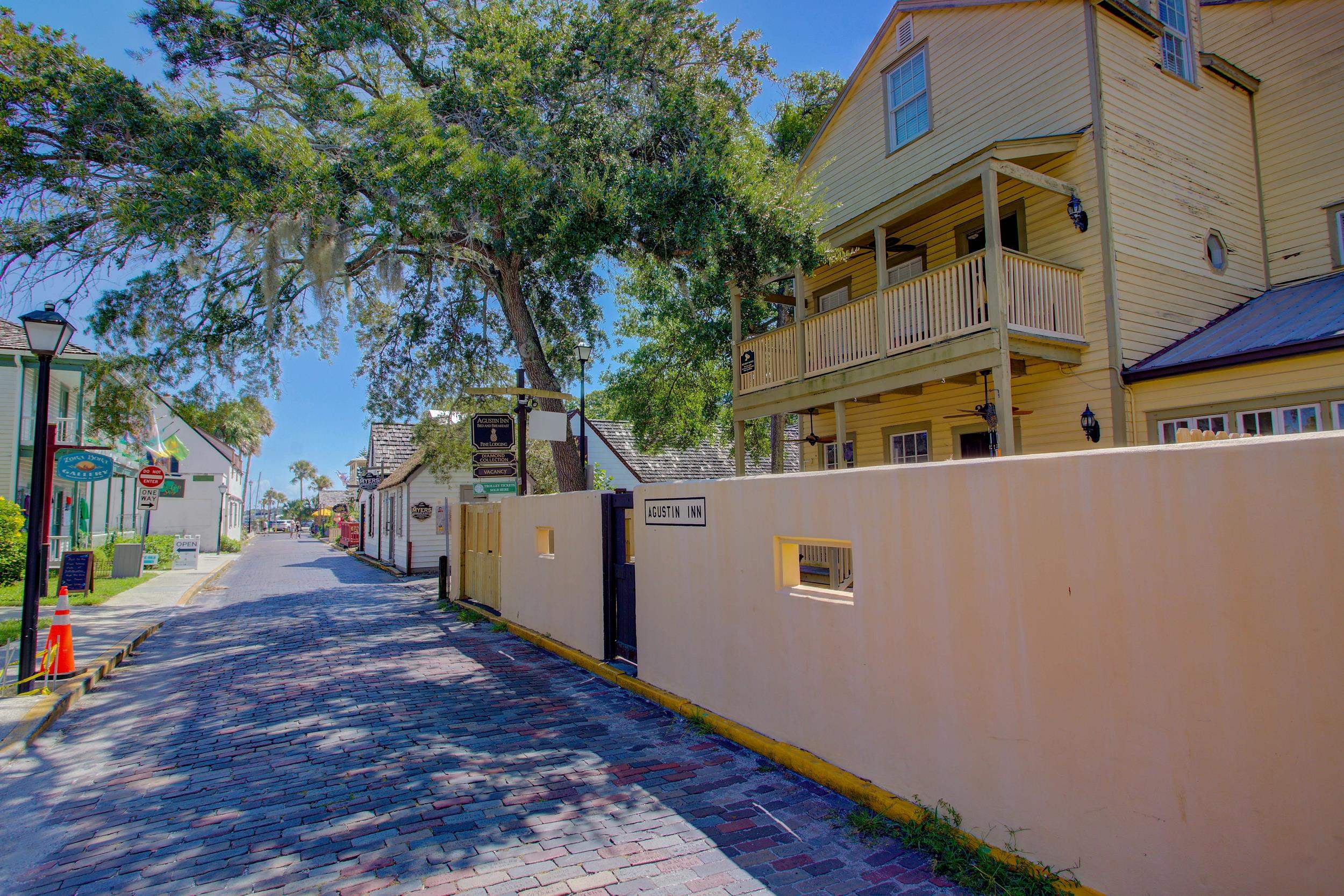 29 Cuna Street St. Augustine, FL 32084 - Photo 58 of 69 View of decorative road with curbs, traffic signs, a gated entry, a residential view, and street lights