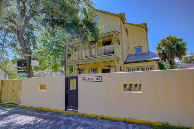a living room with furniture and a dining table