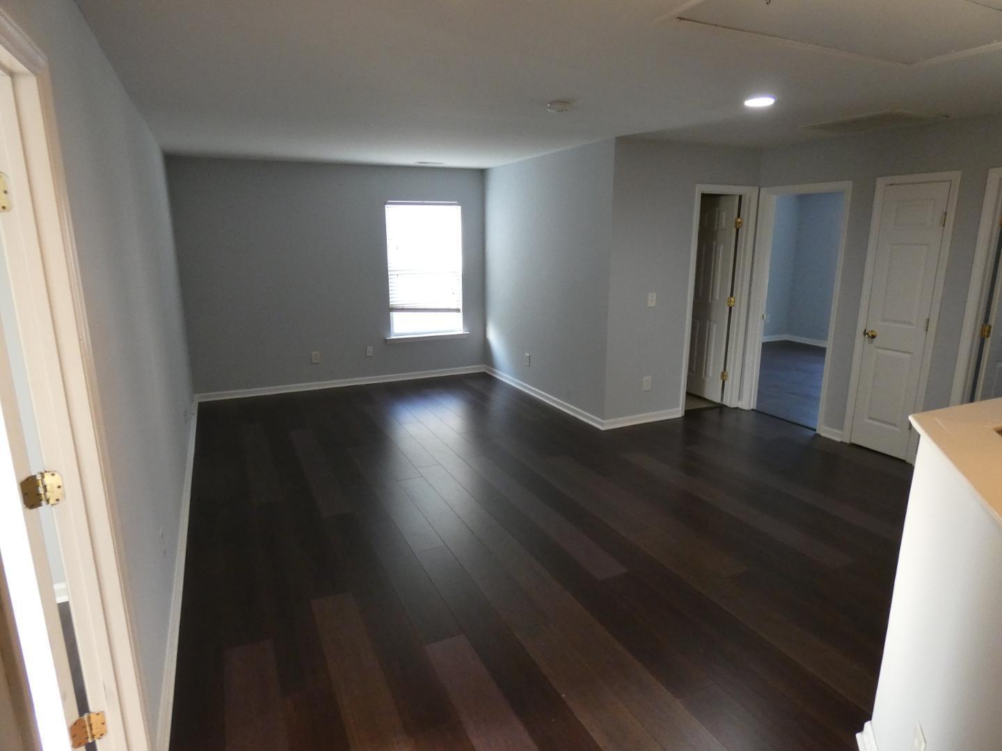 1624 Brown Owl Drive Raleigh, NC 27610 - Photo 14 of 22 an empty room with wooden floor and windows