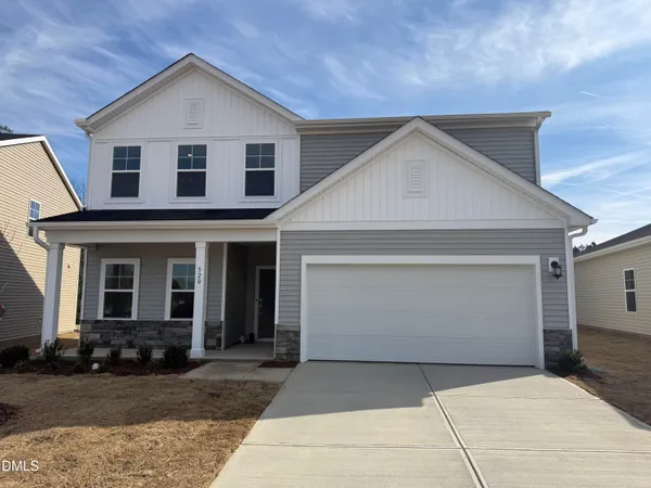 a front view of a house with yard