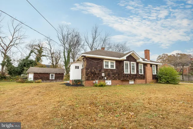 a front view of a house with yard and mountain view