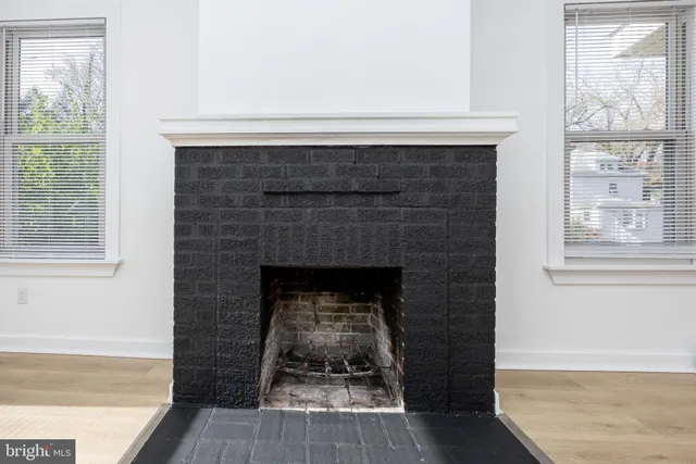 a living room with a fireplace and a floor