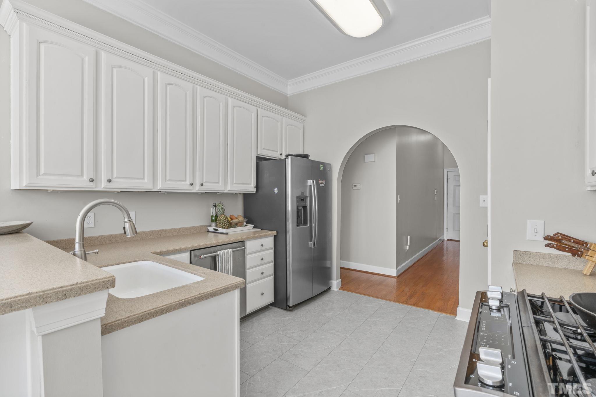 2904 Sunnystone Way Raleigh, NC 27613 - Photo 14 of 51 a kitchen with stainless steel appliances granite countertop a refrigerator and a stove top oven
