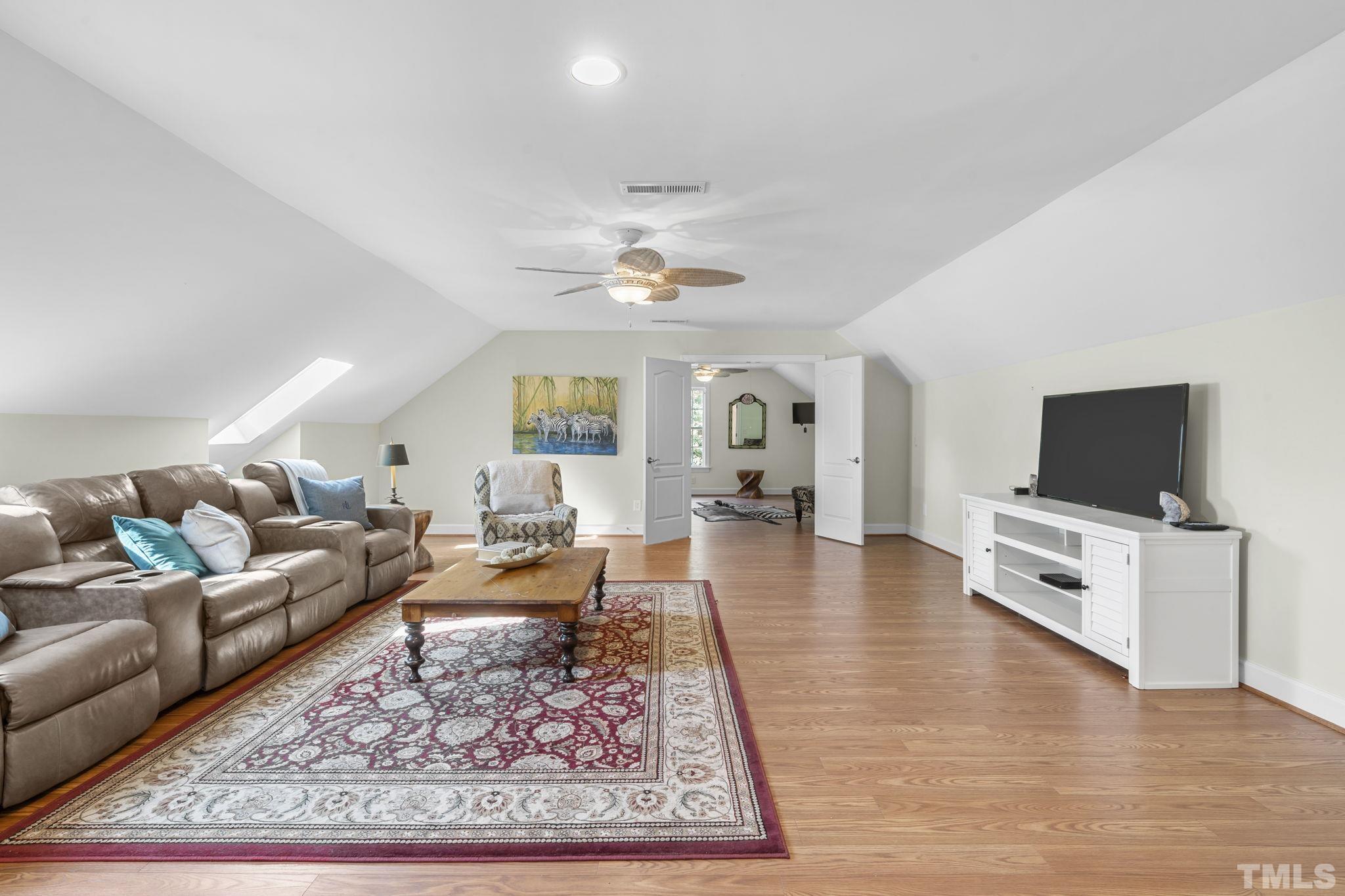2904 Sunnystone Way Raleigh, NC 27613 - Photo 33 of 51 a living room with furniture and a flat screen tv