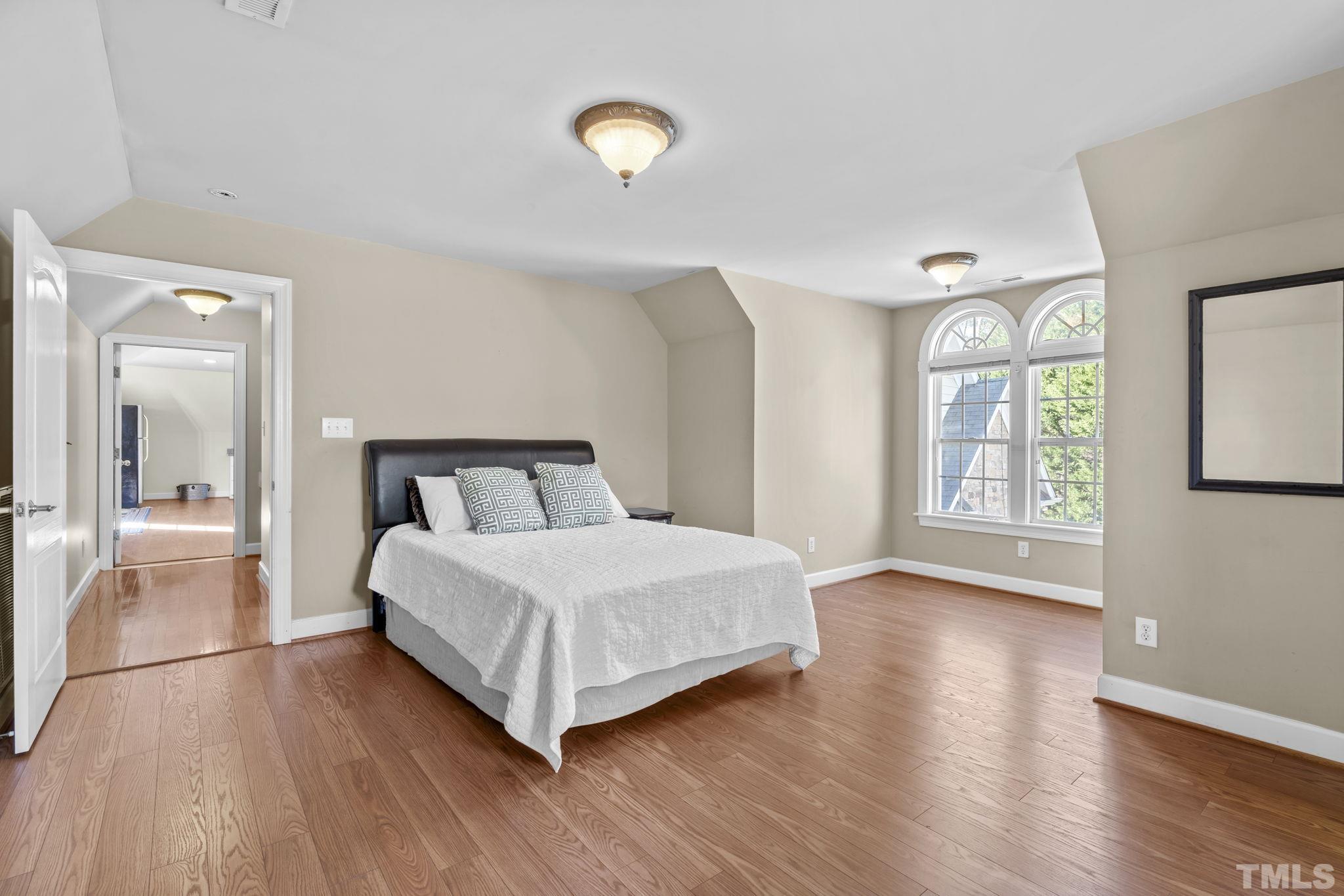 2904 Sunnystone Way Raleigh, NC 27613 - Photo 40 of 51 a bedroom with a bed and a large window