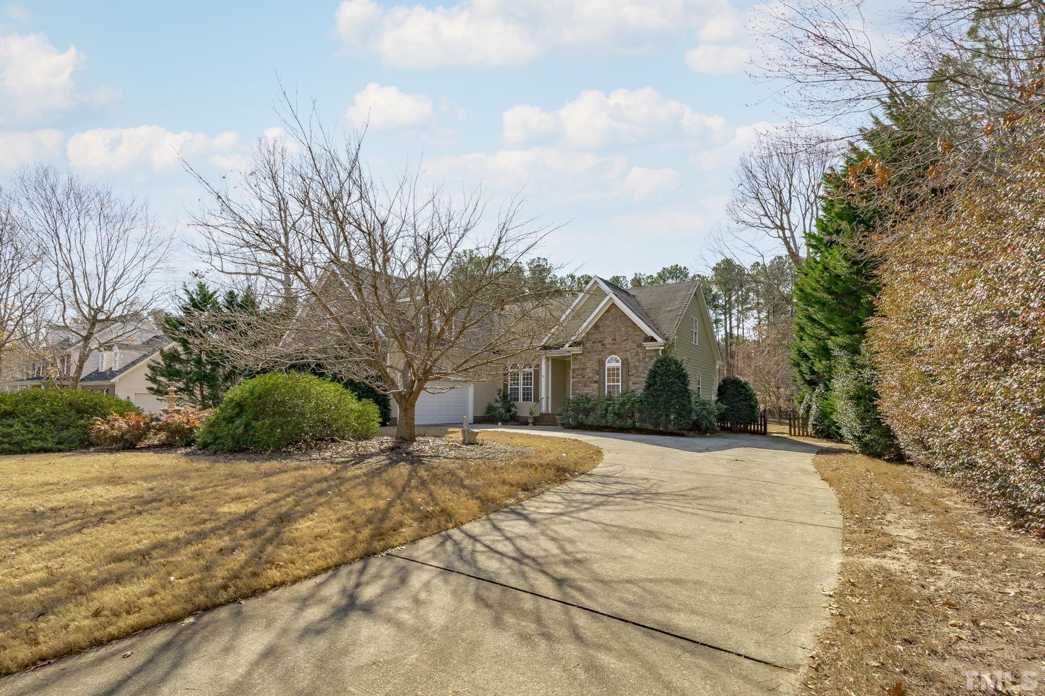 2904 Sunnystone Way Raleigh, NC 27613 - Photo 4 of 51 a front view of a house with a yard and garage
