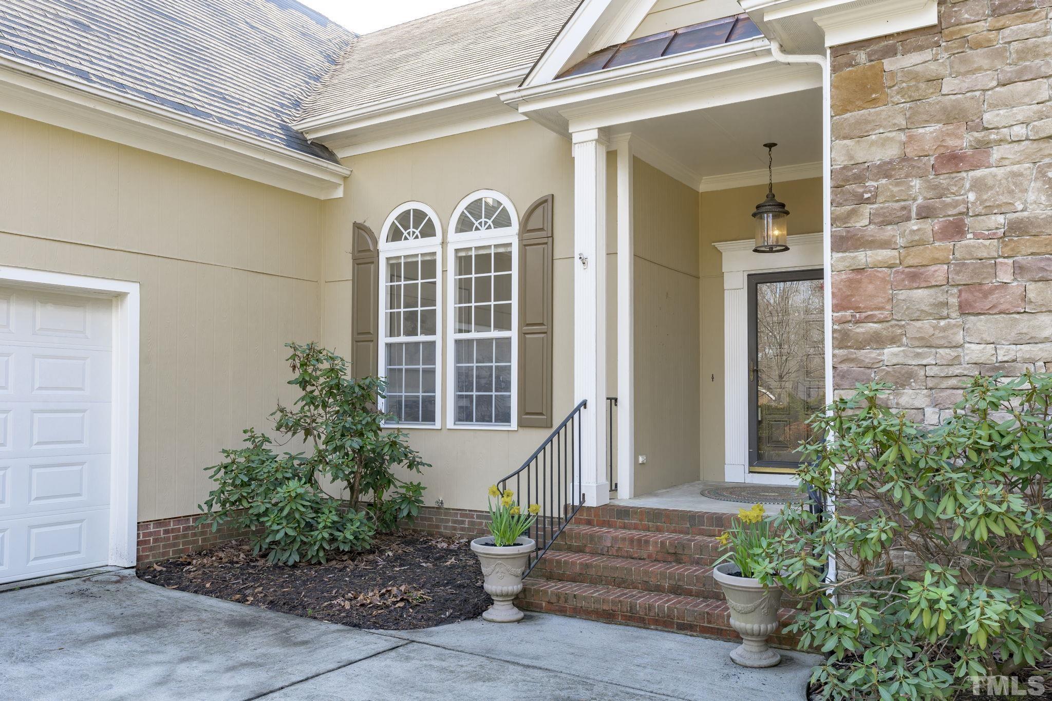 2904 Sunnystone Way Raleigh, NC 27613 - Photo 5 of 51 a view of a brick house with potted plants