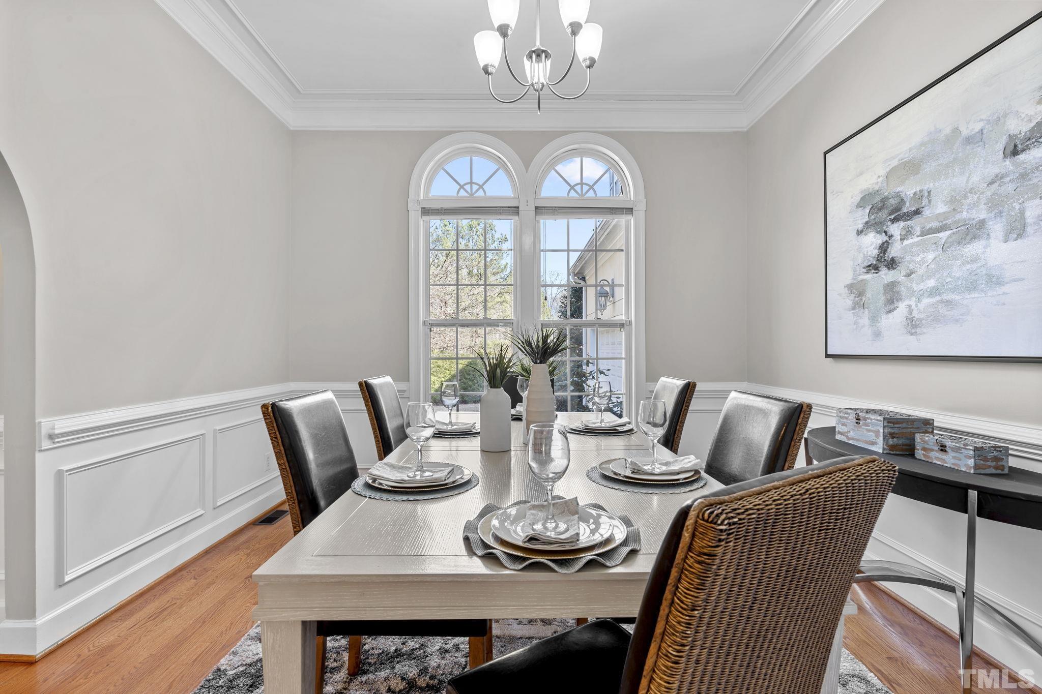 2904 Sunnystone Way Raleigh, NC 27613 - Photo 9 of 51 a view of a dining room with furniture a chandelier and a window