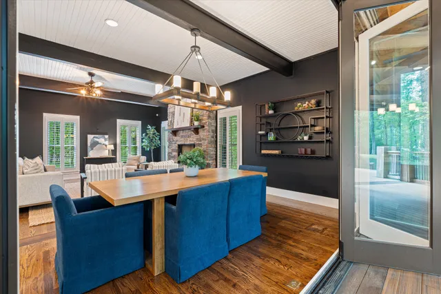 a kitchen with stainless steel appliances granite countertop a sink a microwave oven and a dining table with wooden floor