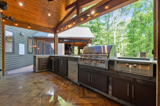 a view of a hallway with wooden floors and cabinet