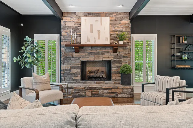 a living room with furniture ceiling fan and a rug
