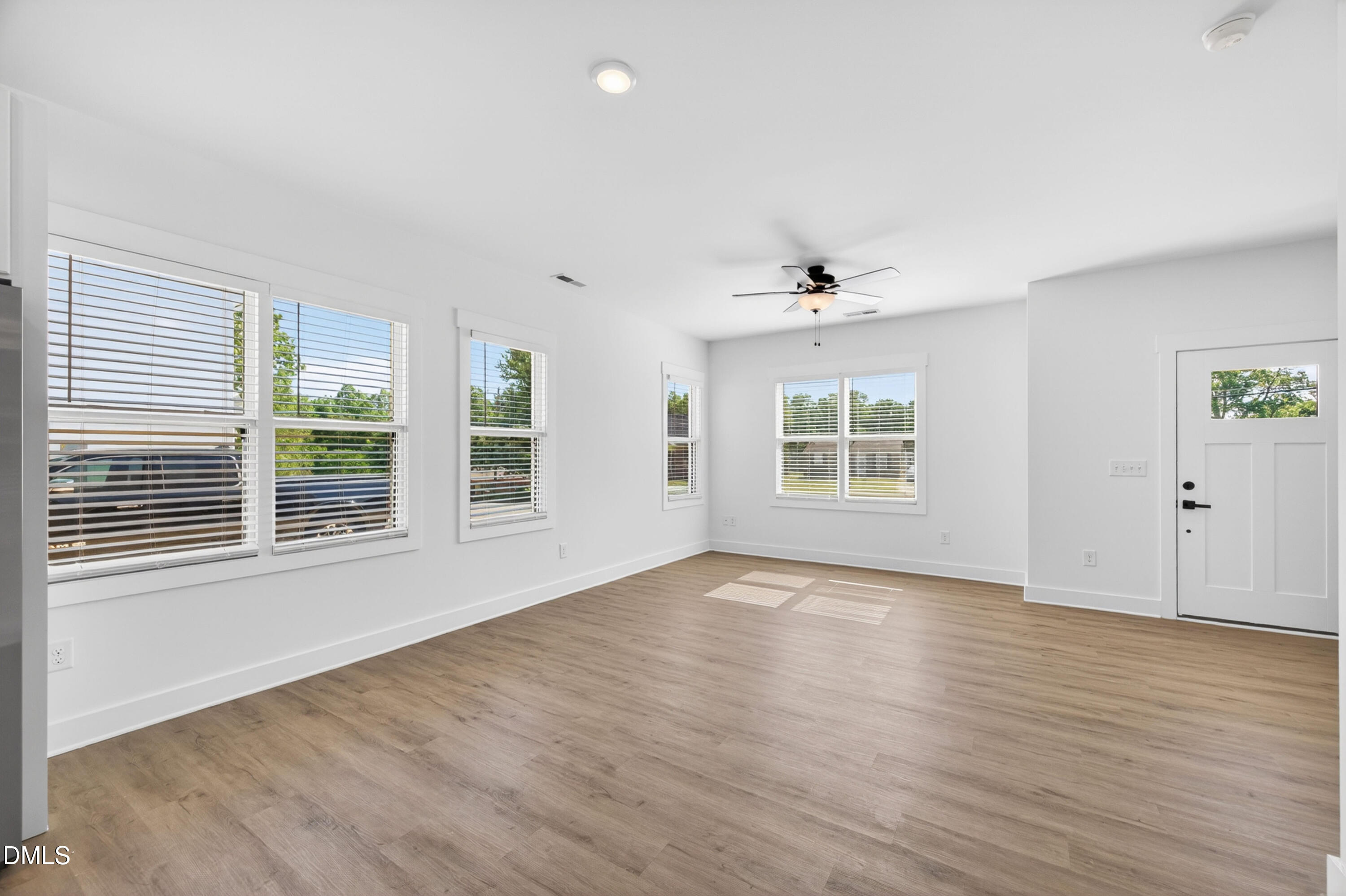 1196 Hurdle Mills Road Roxboro, NC 27573 - Photo 11 of 50 a view of an empty room with wooden floor and a window