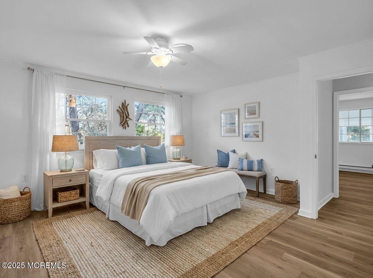 6 Berkeley Street, Unit 64 Whiting, NJ 08759 - Photo 14 of 31 a bedroom with a large bed and a chandelier