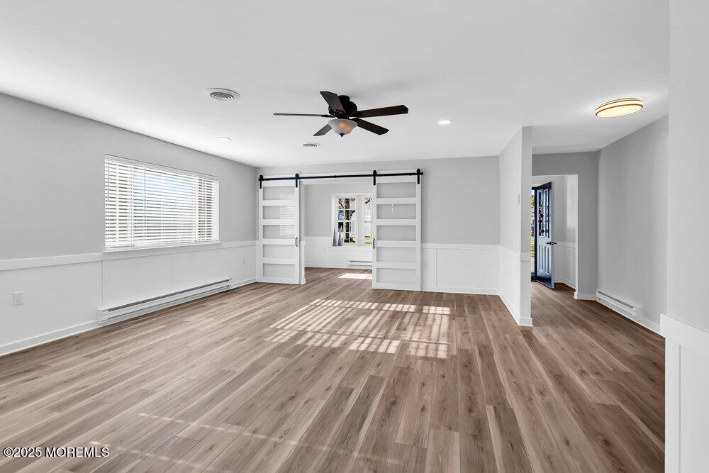 6 Berkeley Street, Unit 64 Whiting, NJ 08759 - Photo 17 of 31 wooden floor in an empty room with a window