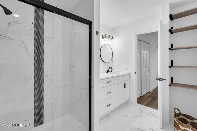a bathroom with a double vanity sink mirror and shower