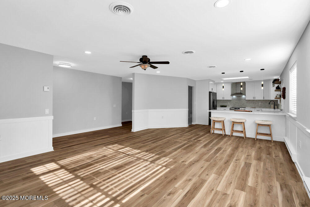 6 Berkeley Street, Unit 64 Whiting, NJ 08759 - Photo 18 of 31 a large white kitchen with kitchen island a sink stainless steel appliances and cabinets