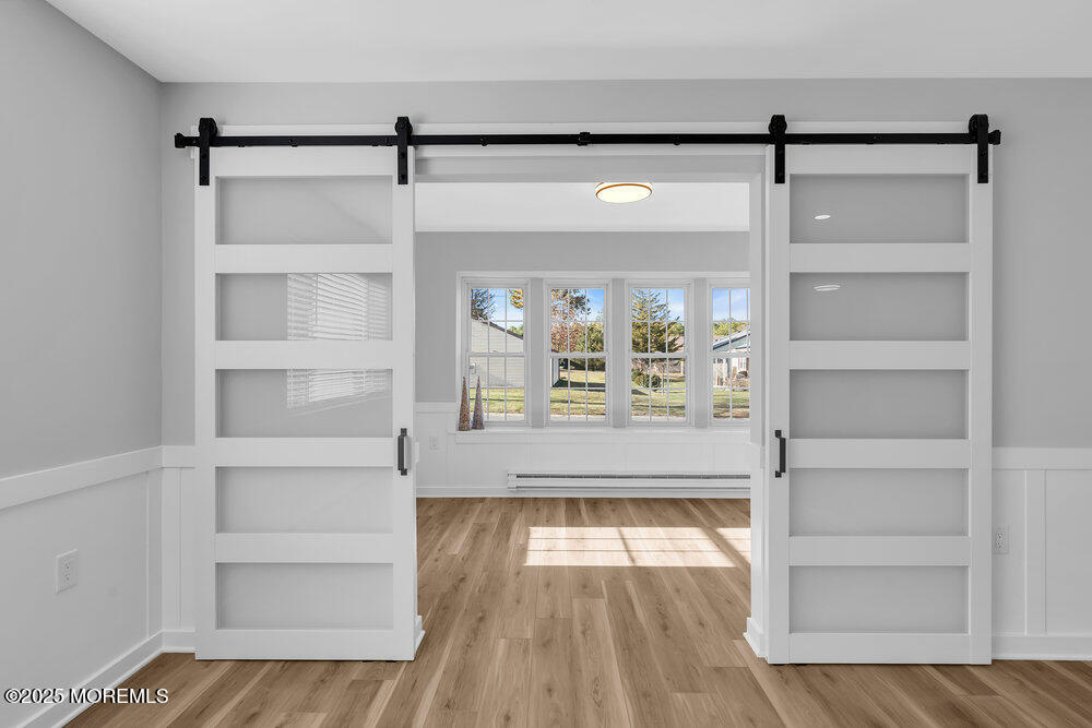 6 Berkeley Street, Unit 64 Whiting, NJ 08759 - Photo 19 of 31 a view of an empty room with a window and wooden floor