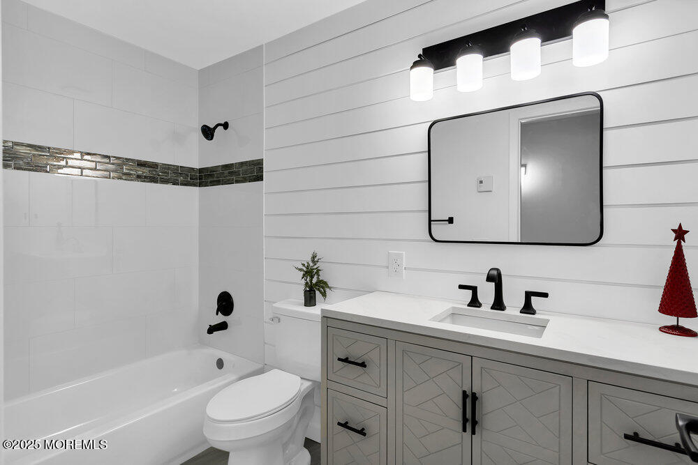 6 Berkeley Street, Unit 64 Whiting, NJ 08759 - Photo 23 of 31 a bathroom with a toilet sink a mirror a bathtub and shower