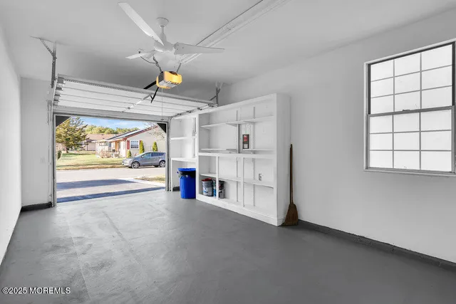 an empty room with fireplace and windows