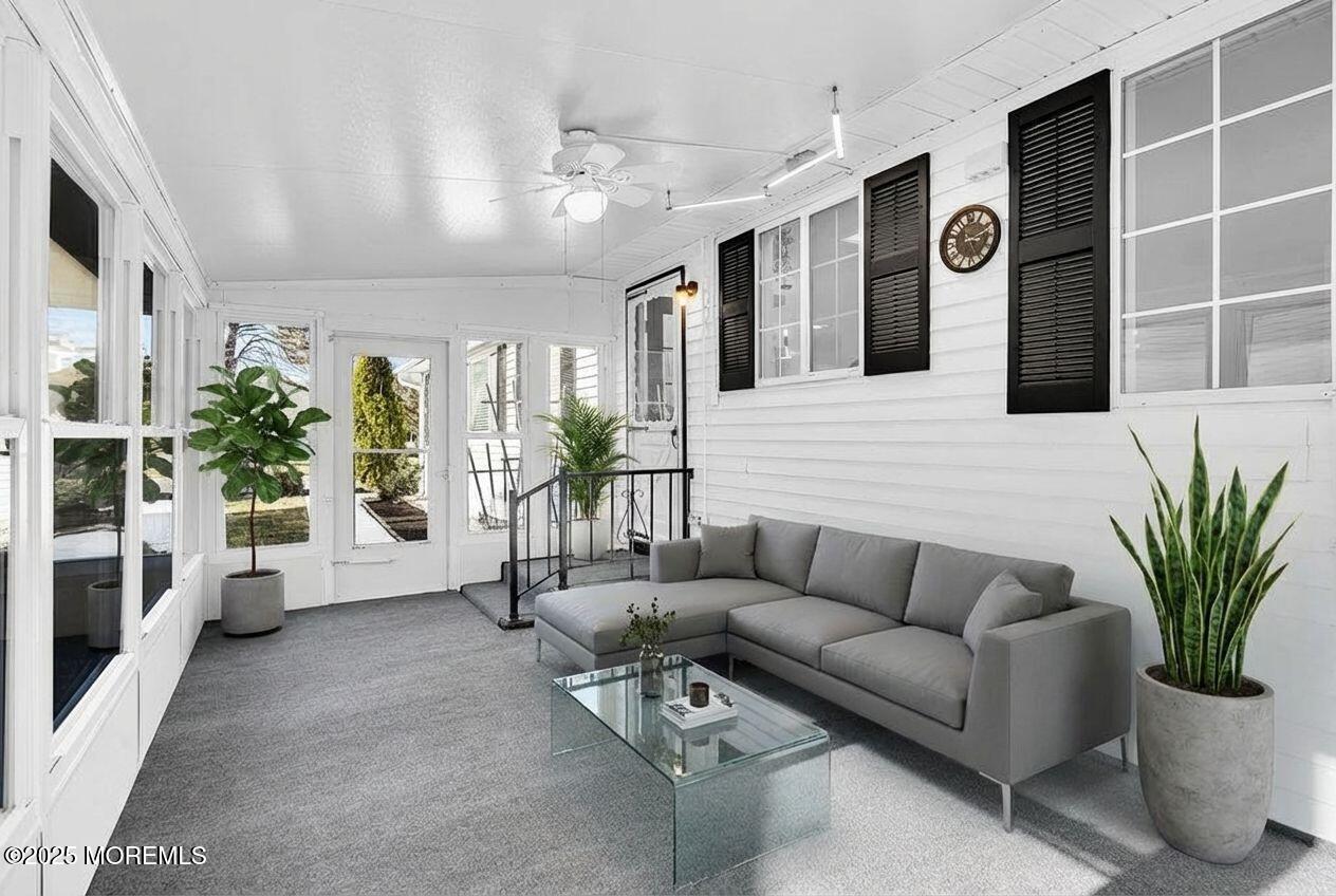 6 Berkeley Street, Unit 64 Whiting, NJ 08759 - Photo 25 of 31 a living room with furniture potted plant and glass door