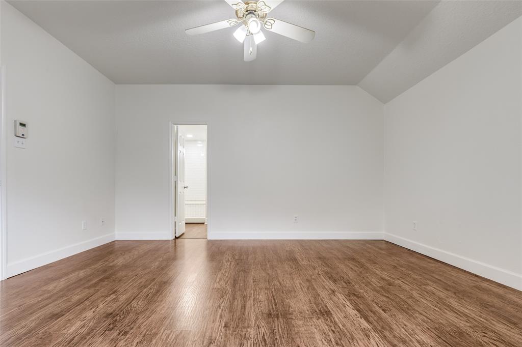 1314 Coppercrest Drive Spring, TX 77386 - Photo 12 of 22 an empty room with wooden floor and windows