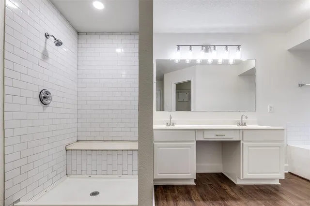 a bathroom with a sink a large mirror and a bathtub