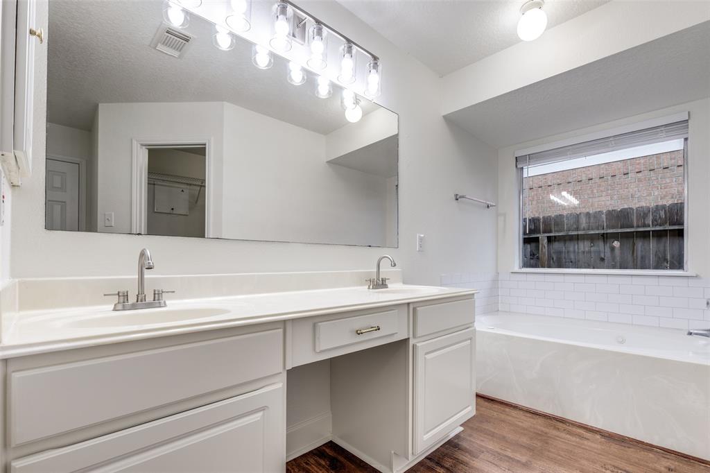 1314 Coppercrest Drive Spring, TX 77386 - Photo 14 of 22 a bathroom with a sink a large mirror and a bathtub