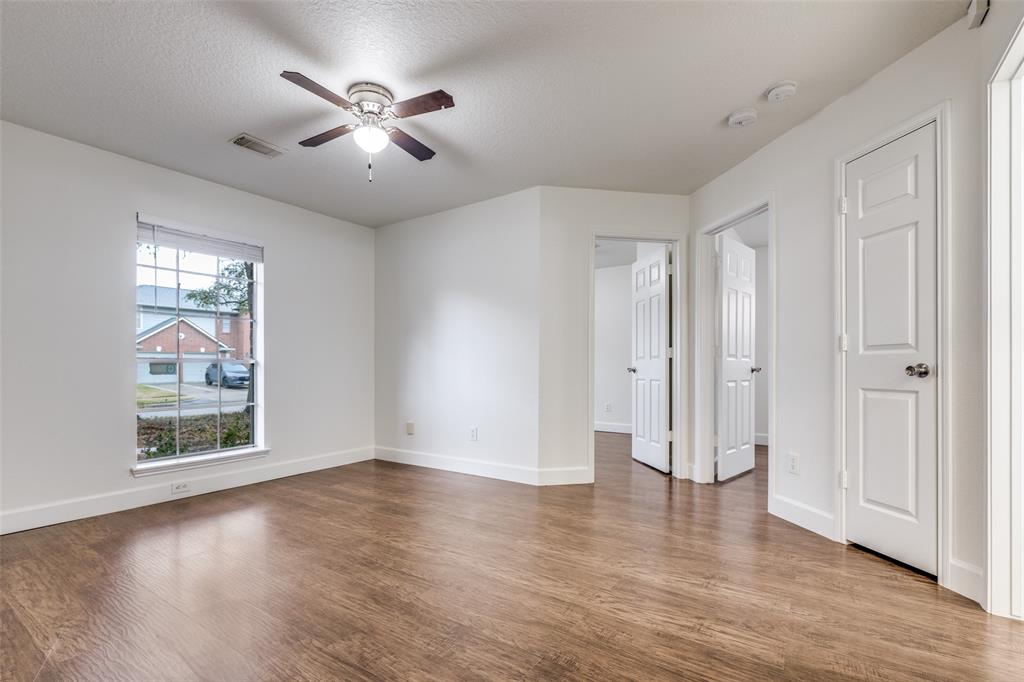 1314 Coppercrest Drive Spring, TX 77386 - Photo 16 of 22 an empty room with wooden floor and windows