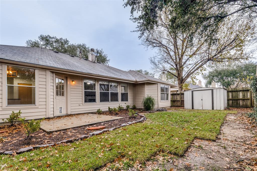 1314 Coppercrest Drive Spring, TX 77386 - Photo 20 of 22 a front view of house with yard outdoor seating and barbeque oven