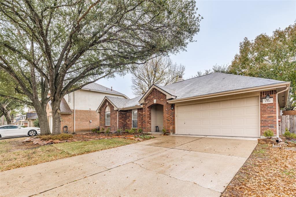 1314 Coppercrest Drive Spring, TX 77386 - Photo 22 of 22 a front view of a house with a yard and garage
