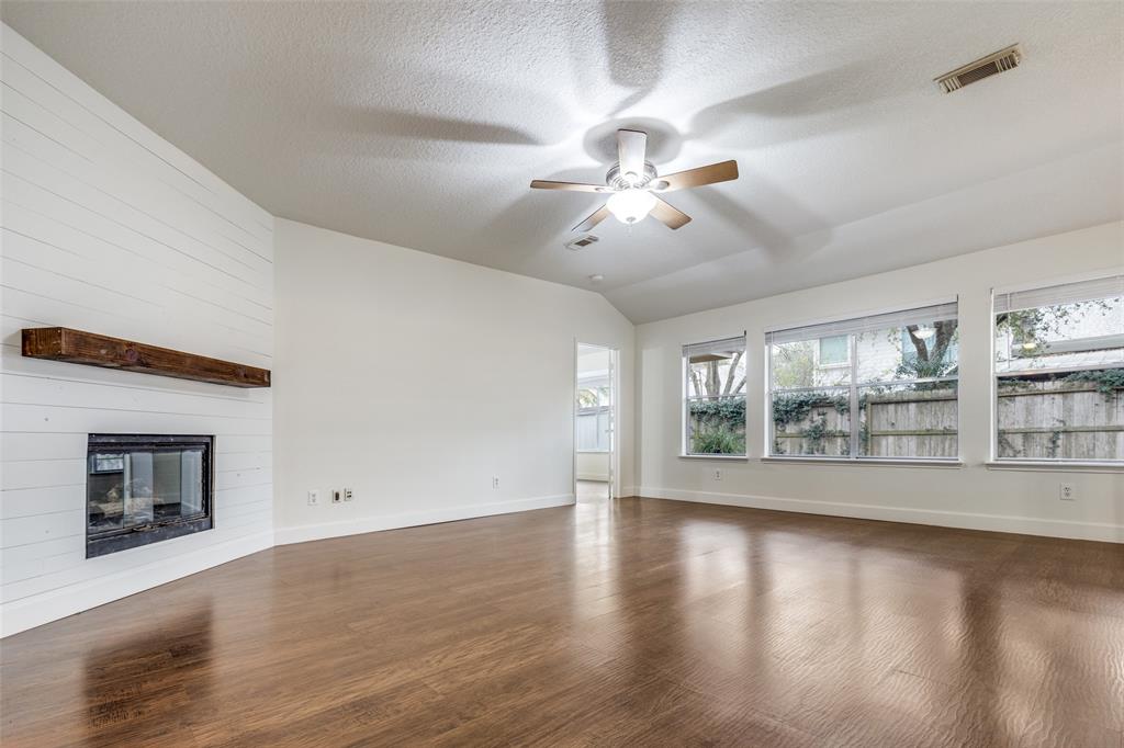1314 Coppercrest Drive Spring, TX 77386 - Photo 3 of 22 a view of an empty room with wooden floor and a window