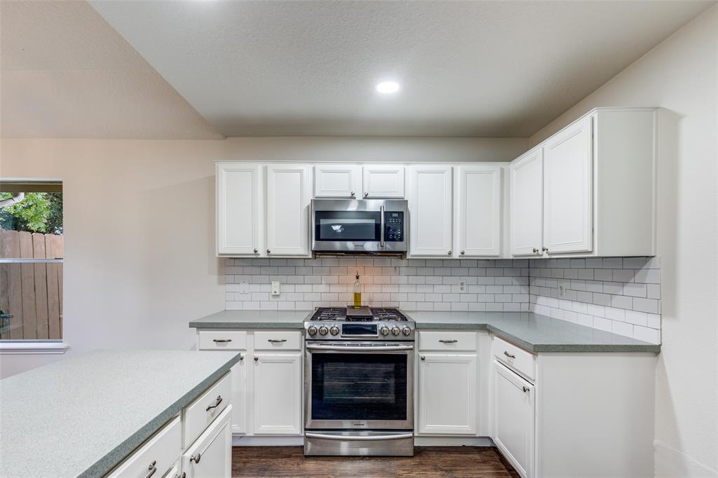 1314 Coppercrest Drive Spring, TX 77386 - Photo 8 of 22 a kitchen with a stove and a sink