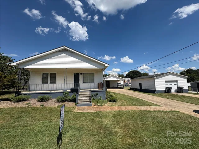 a front view of a house with a yard fire pit and outdoor seating