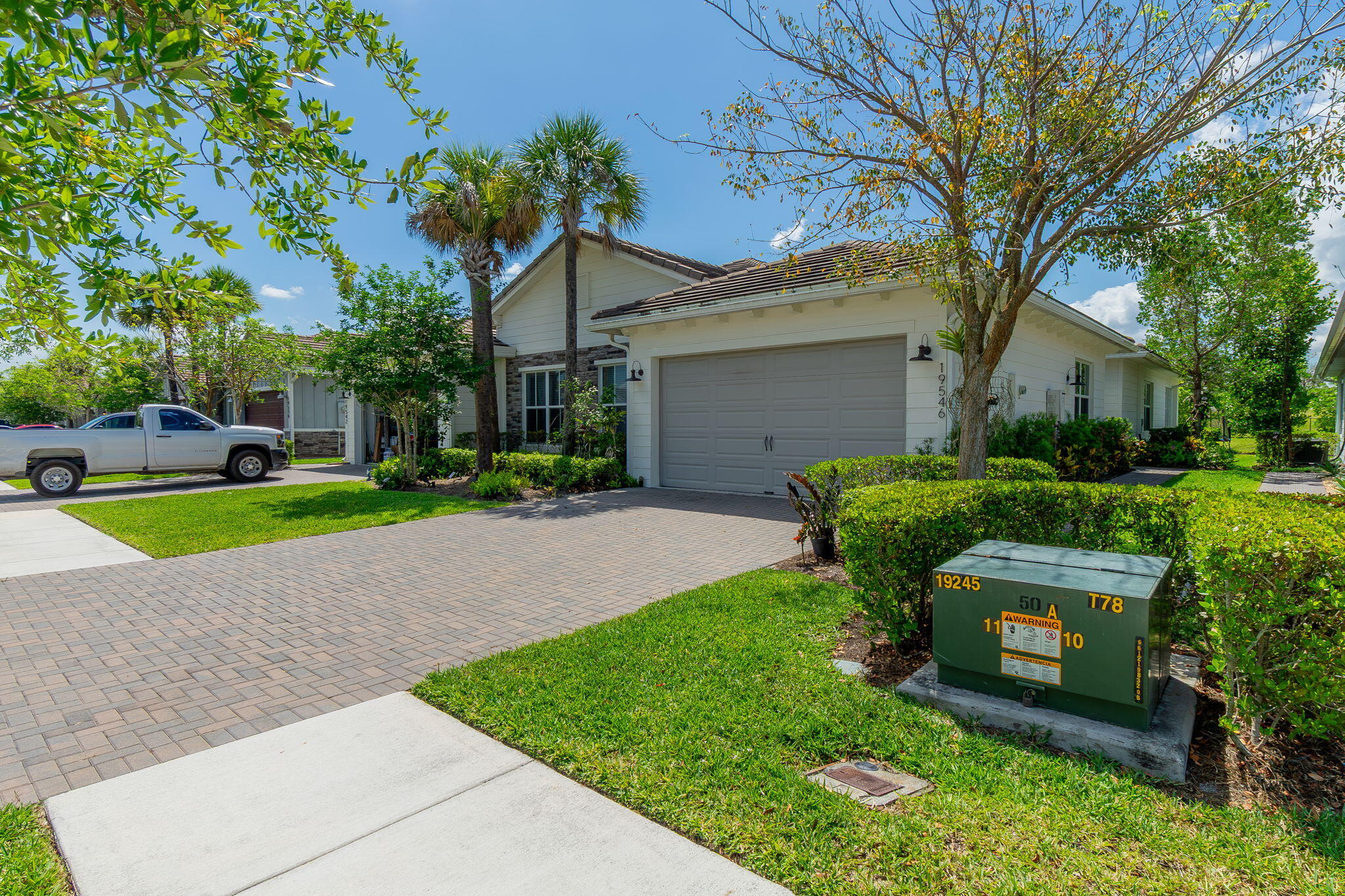 19546 Weathervane Way Loxahatchee, FL 33470 - Photo 3 of 63 a front view of a house with a yard and garage