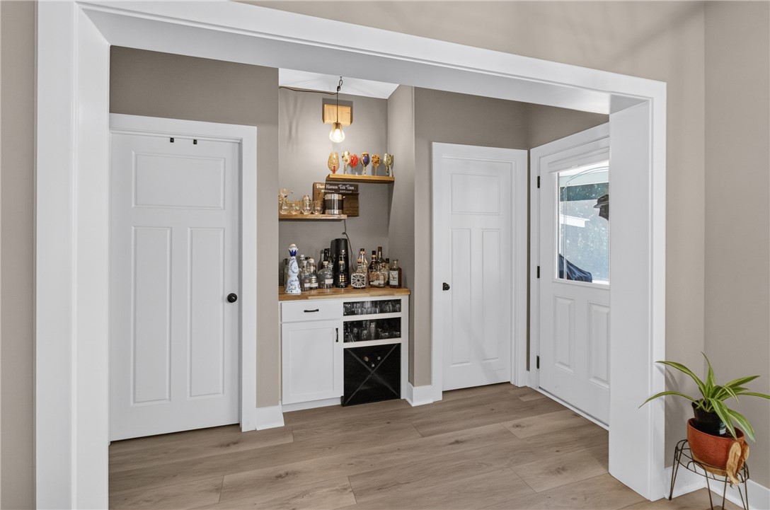 1504 Double Springs Road Townville, SC 29689 - Photo 14 of 49 A dedicated home bar alcove sits adjacent to the light-filled entryway featuring durable wood-look floors.
