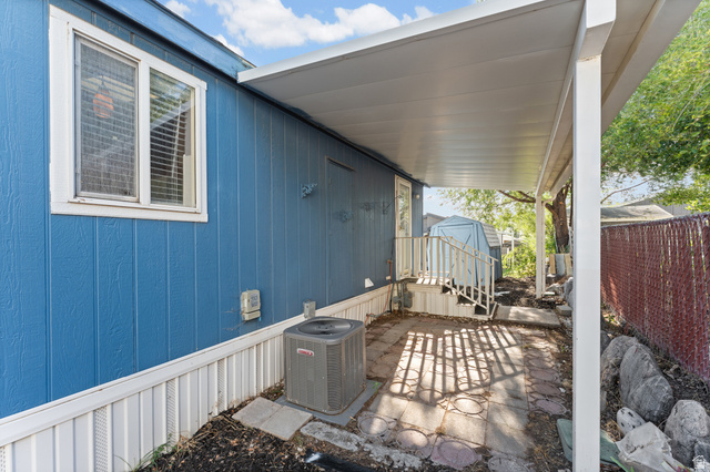 312 Harriger Way Layton, UT 84041 - Photo 31 of 36 Covered patio space featuring a concrete slab and access to exterior stairs