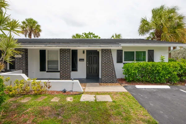 front view of a house with yard patio and fire pit
