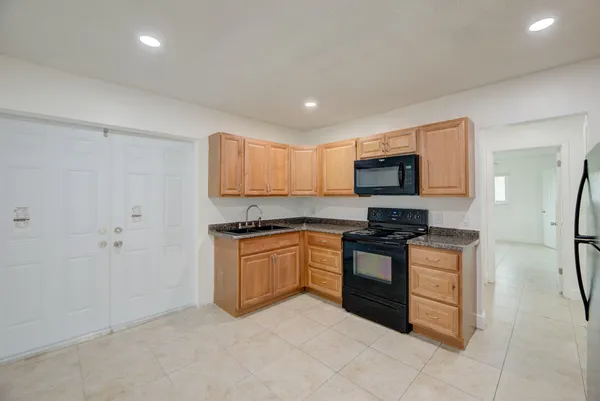 a kitchen with granite countertop stainless steel appliances and a sink