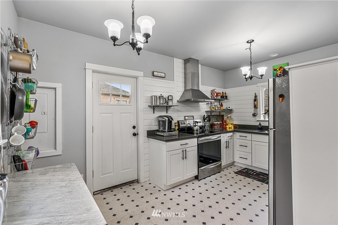 3020 Gedney Street Everett, WA 98201 - Photo 22 of 40 a kitchen with stainless steel appliances granite countertop a refrigerator a stove top oven a sink and dishwasher