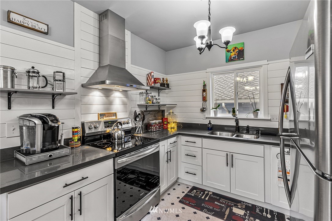 3020 Gedney Street Everett, WA 98201 - Photo 23 of 40 a kitchen with granite countertop a sink stainless steel appliances and cabinets
