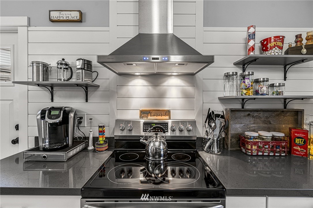 3020 Gedney Street Everett, WA 98201 - Photo 24 of 40 a kitchen with kitchen island granite countertop a stove and a sink
