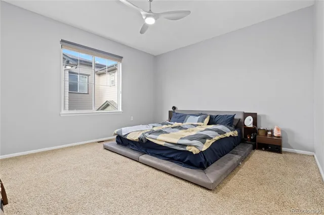 a bedroom with bed and window