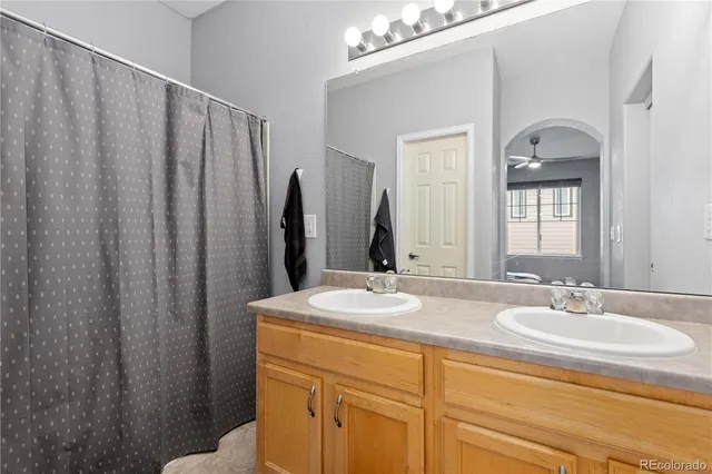 a bathroom with double vanity sink and a mirror