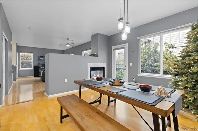 a living room with furniture a large window and a fireplace